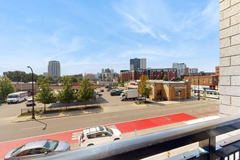 A city street with cars and buildings in the background.